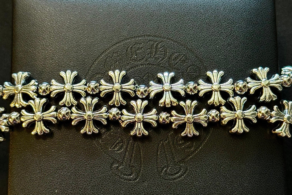 Silver bracelet on a black box with a brand logo